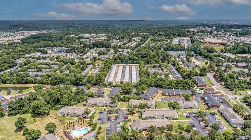 an aerial view of a city with houses and trees