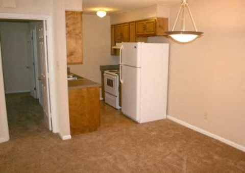 a kitchen with a white refrigerator and a stove