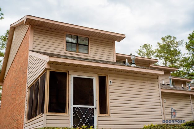 the front of a remodeled house with the front door open