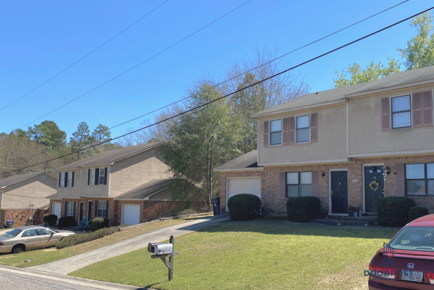 a house with a yard and a mailbox in front of it
