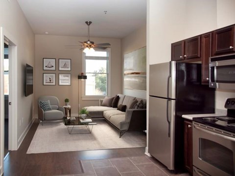 a living room with a couch and a refrigerator