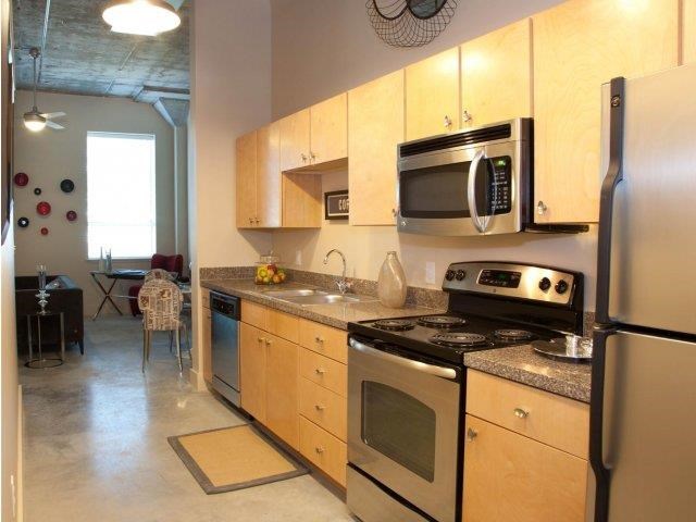 a kitchen with stainless steel appliances and wooden cabinets