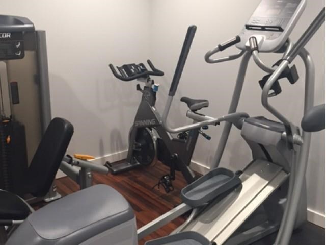 the gym has a lot of exercise equipment