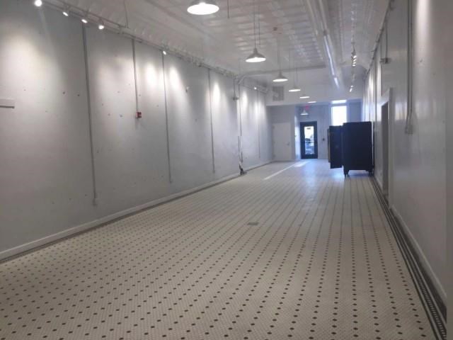 a long hallway in a building with a tile floor
