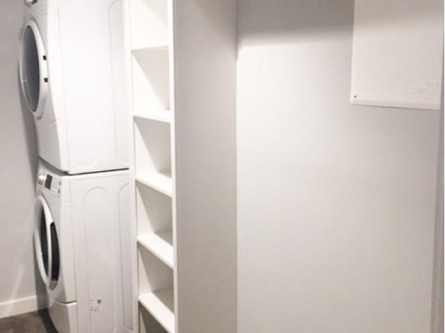 a kitchen with a white refrigerator and a white closet