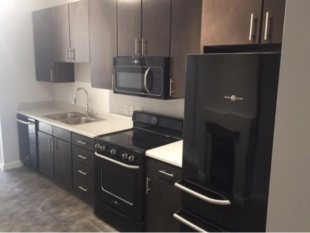 a kitchen with a stove and a refrigerator