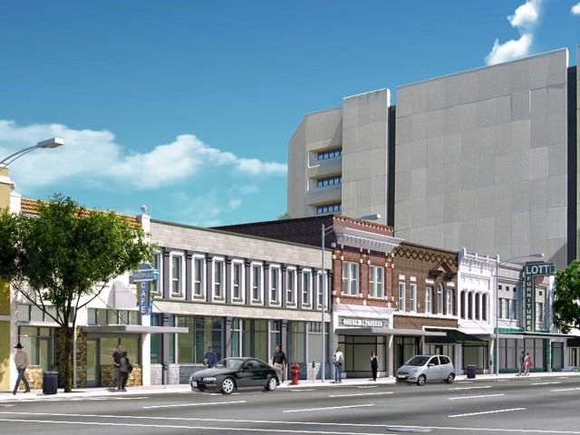 a rendering of a city street with buildings and cars