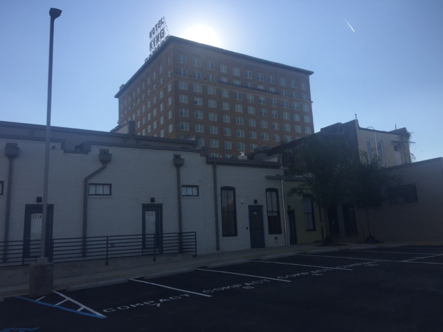 a church with a tall building in the background