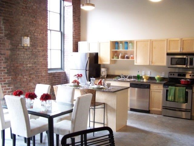 a kitchen and dining room with a table and chairs