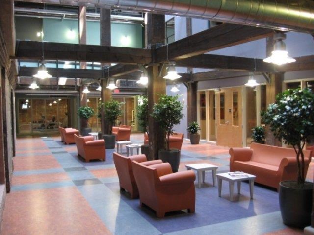 a lobby with couches and tables in a building