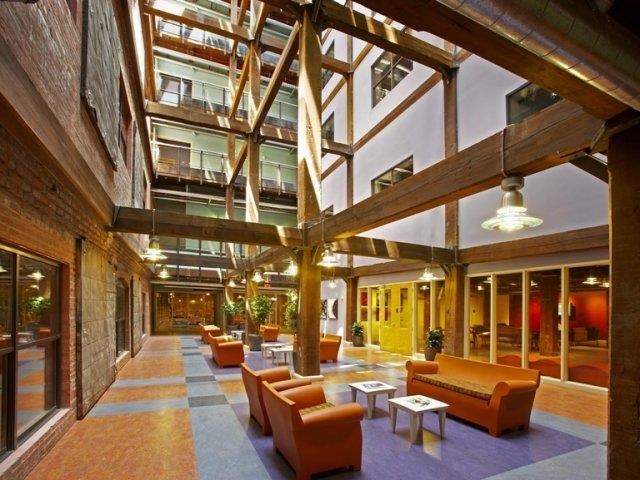 a lobby of a building with couches and tables