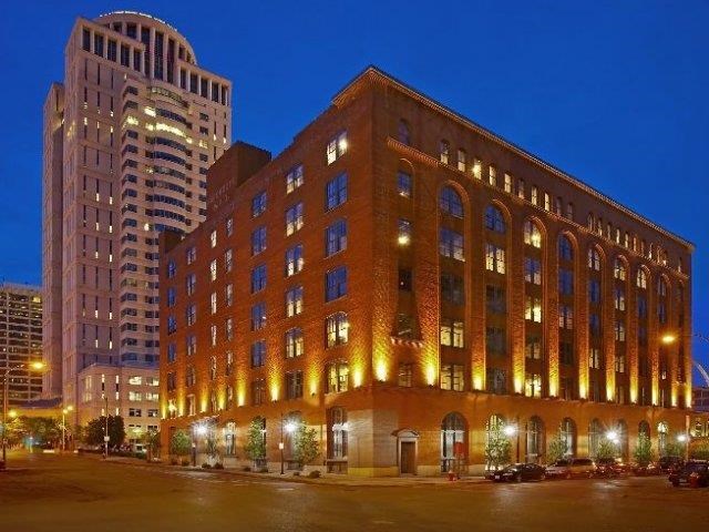 a building is lit up at night on a city street