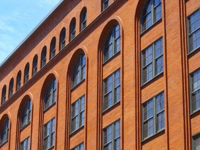 a tall brick building with a row of windows