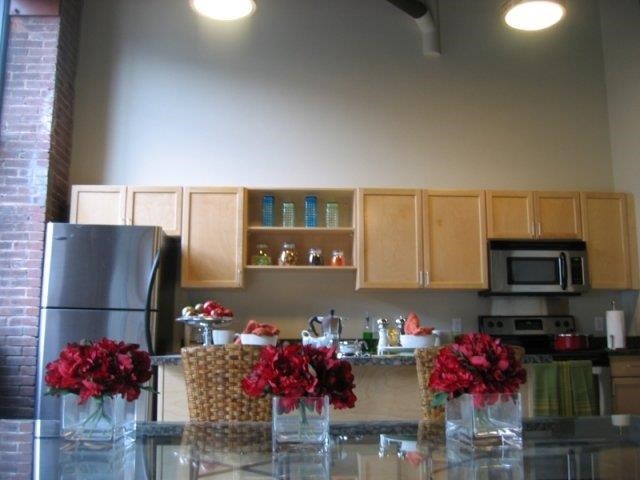 a kitchen with flowers in vases on a counter