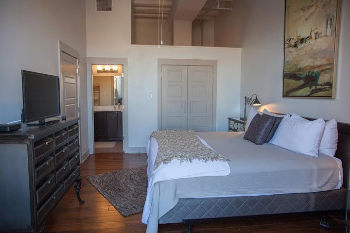 a bedroom with a bed and a tv in it