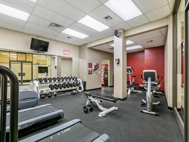a gym with a lot of chairs and weights