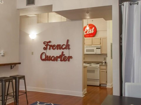 an empty kitchen with a coca cola sign on the wall