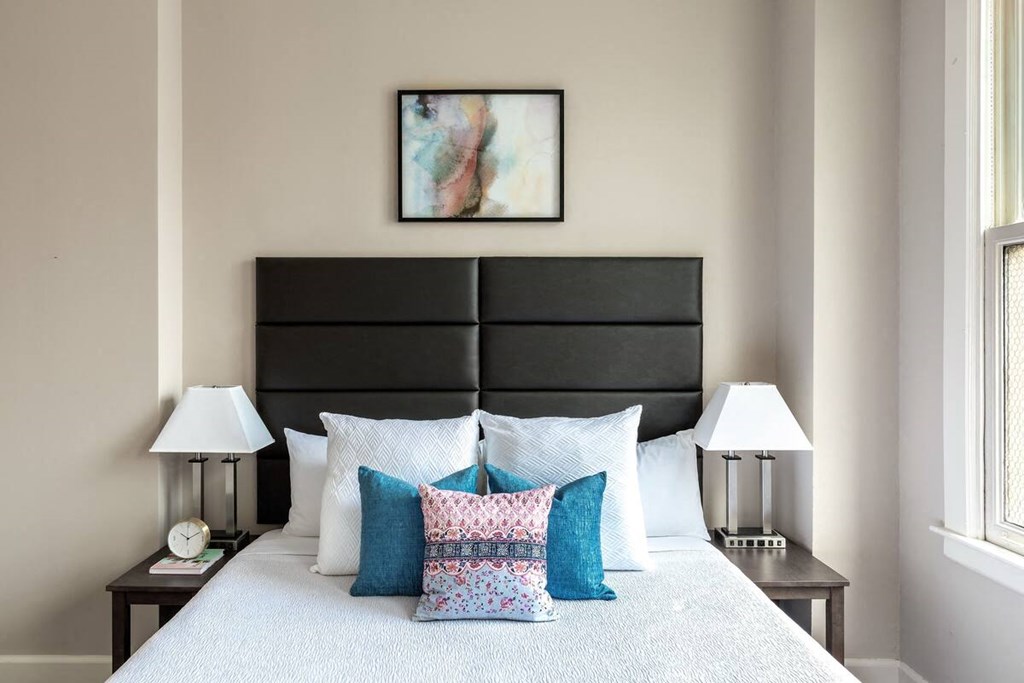 a bedroom with a large bed with pillows on it