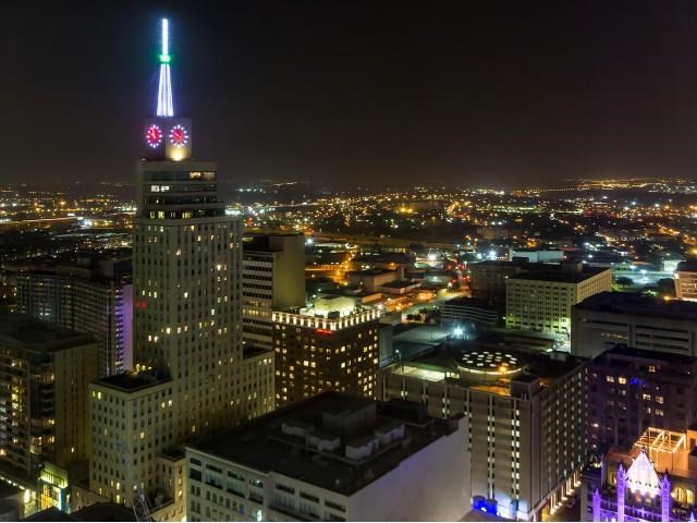 a city skyline at night with the empire state building