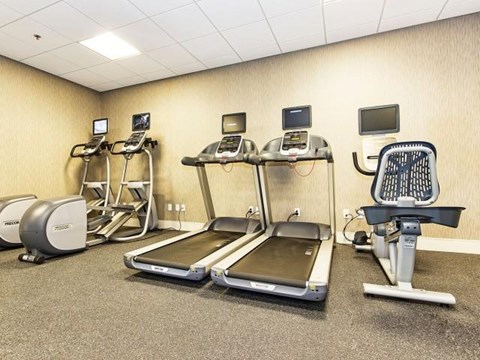 a gym with various exercise equipment in it