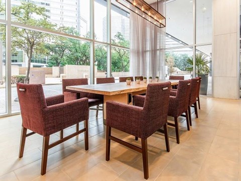a large dining room with a table and chairs