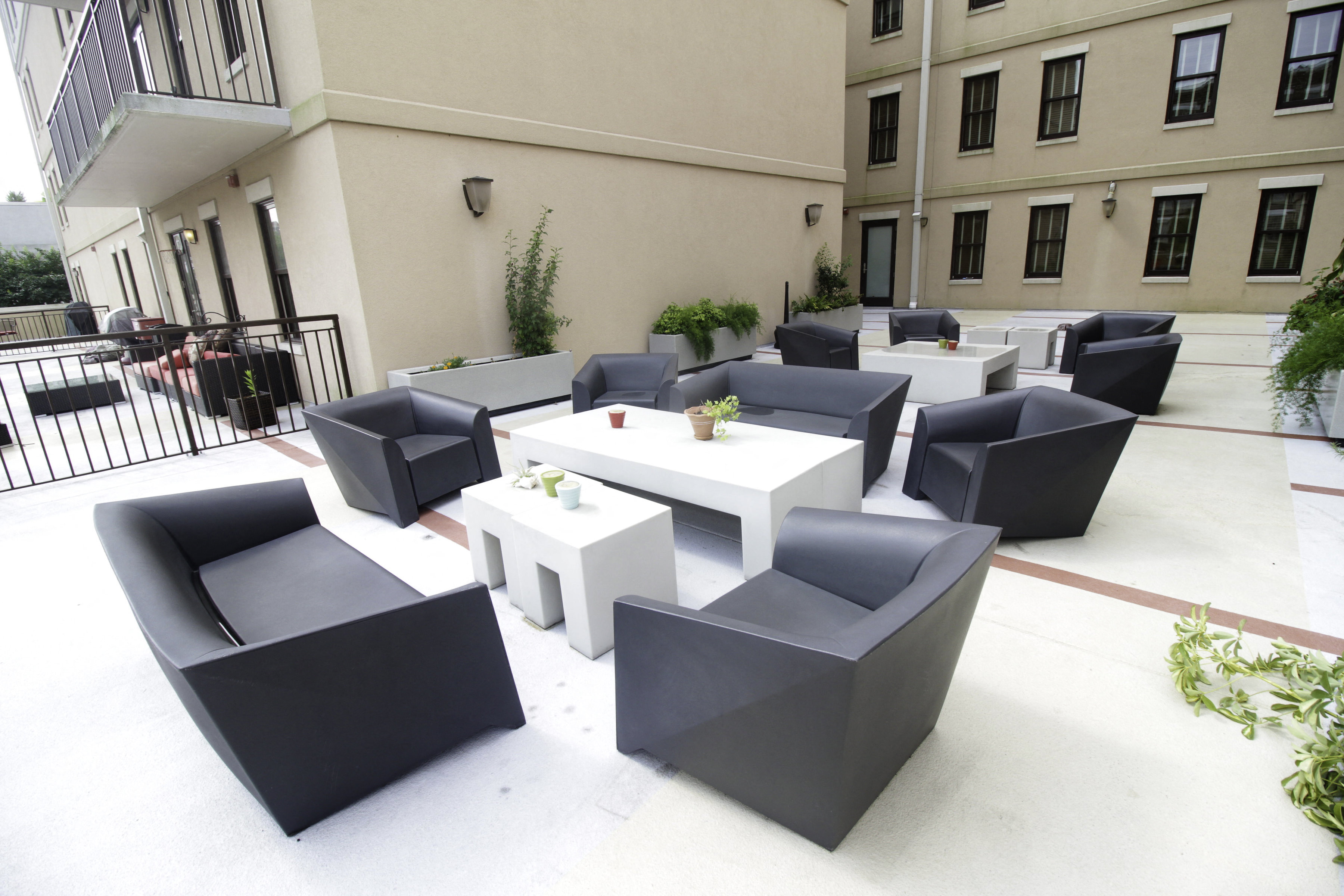 a seating area outside of a building with tables and chairs