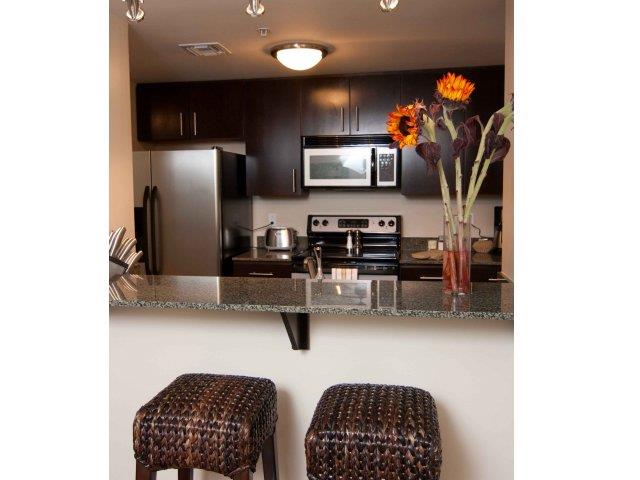 a kitchen with a counter and stools