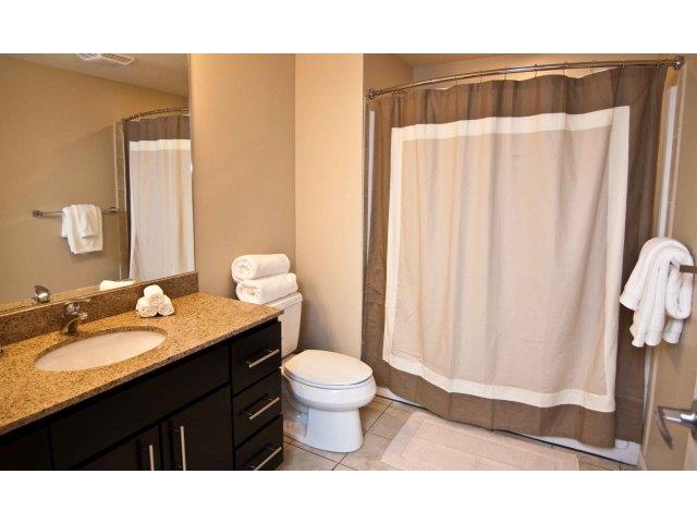 a bathroom with a toilet and a sink and a shower