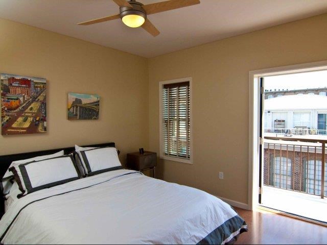 a bedroom with a bed and a ceiling fan