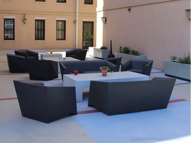 a group of tables and chairs in a patio