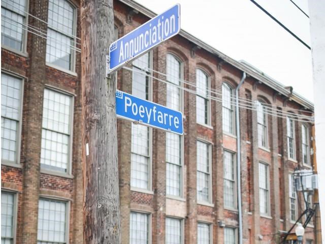 two street signs on a pole in front of a building