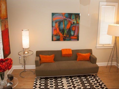 a living room with a couch and a painting
