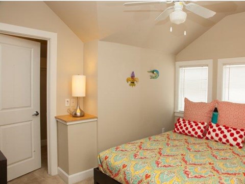 a bedroom with a bed and a ceiling fan