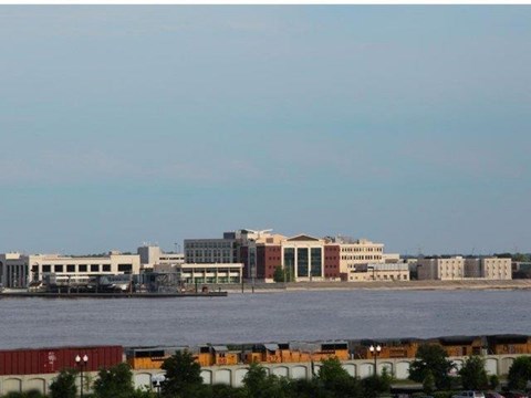 a view of a city and the water with a train