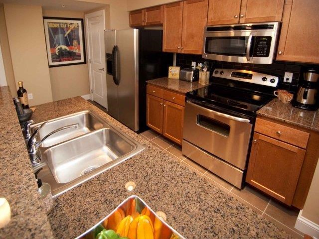 a kitchen with stainless steel appliances and a bowl of fruit