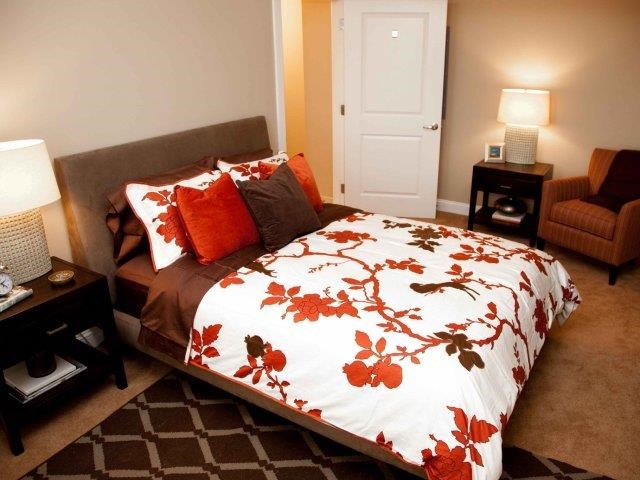 a bedroom with a bed and two lamps