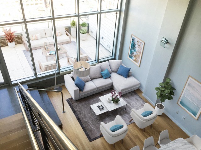 an aerial view of a living room with a couch and chairs