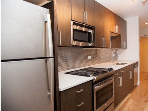 a kitchen with a stove microwave and refrigerator