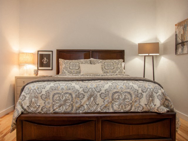 a bedroom with a bed and two lamps