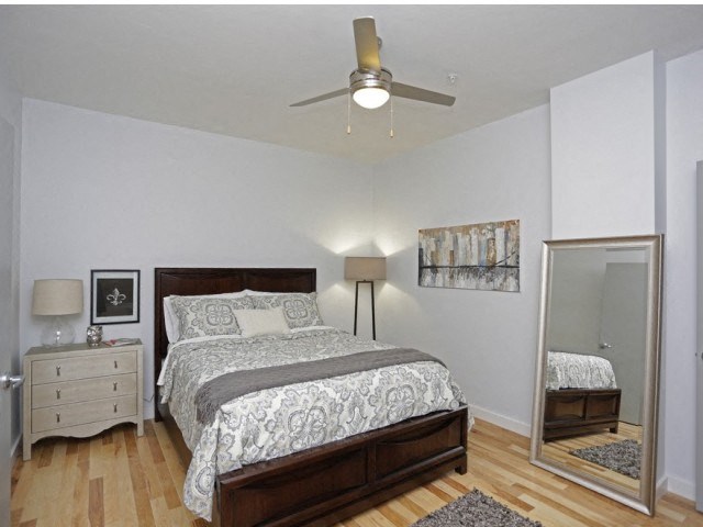 a bedroom with a bed and a ceiling fan