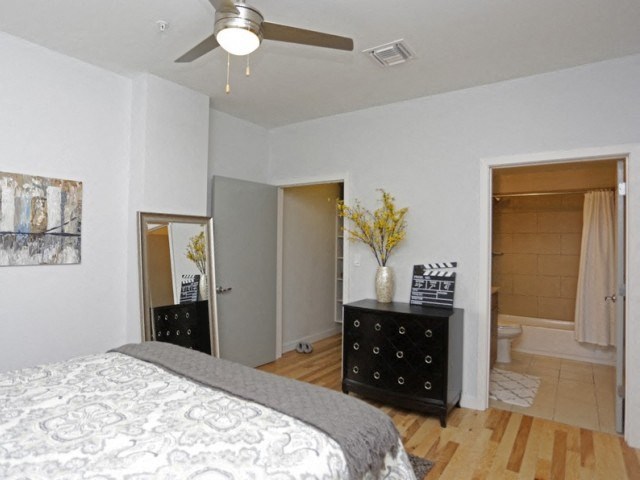 a bedroom with a large bed and a ceiling fan