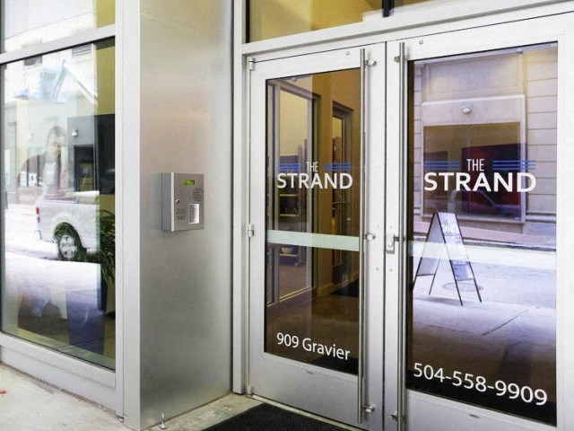 a glass door with a sign on the front of a building