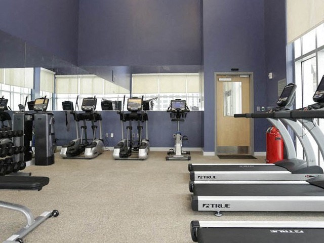 a gym with a lot of machines and weights