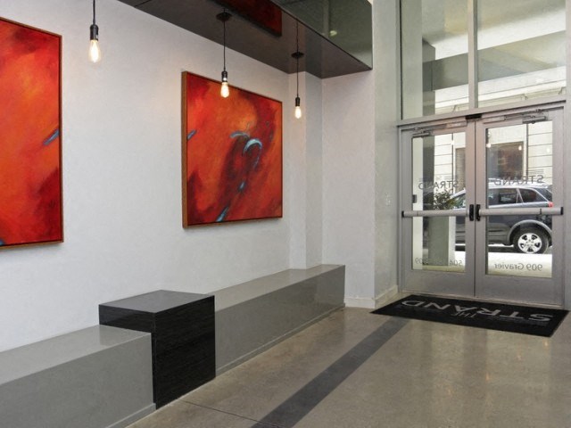 the lobby of a building with paintings and a door