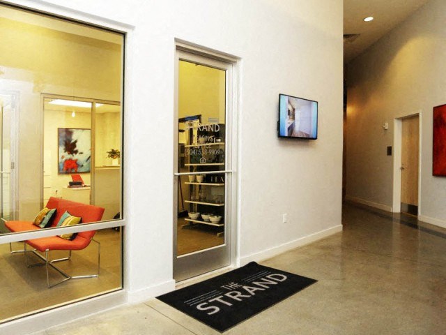 a living room with large mirrors and a rug on the floor