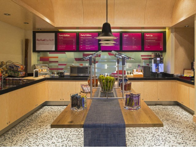 a coffee shop with a table and a menu on the wall