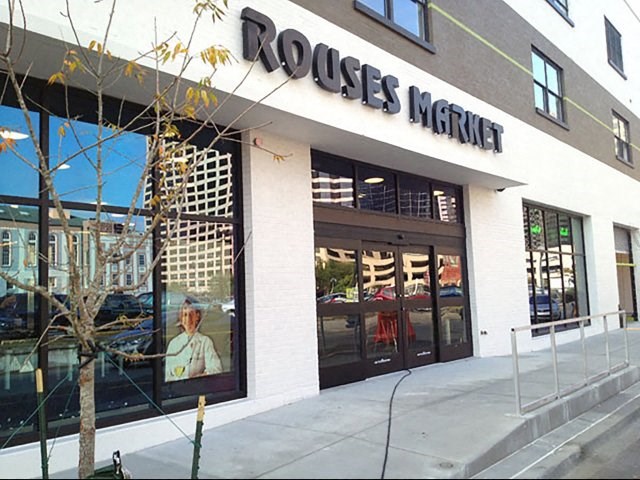 a roches market store with a large window on the side of a building