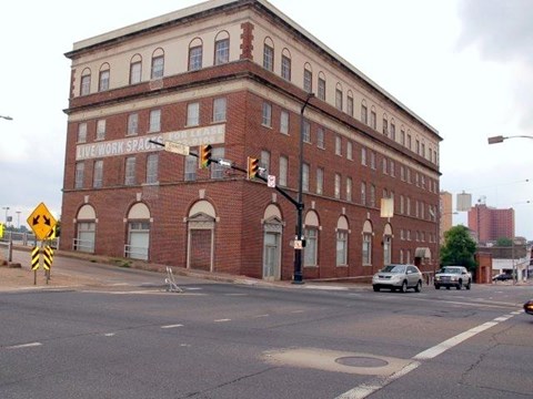 A brick building with a sign that says "LIVE/WORK SPACE" on it.