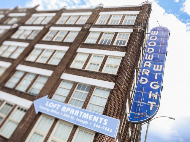 a large building with a blue sign on the side of it