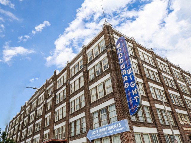 a large building with a blue sign in front of it